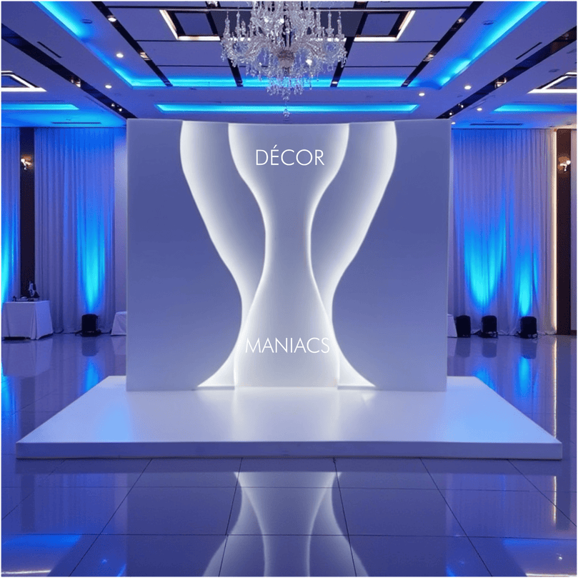 Decorative setup with a white backdrop arch and 'Décor Maniacs' branding in a room with blue lighting.